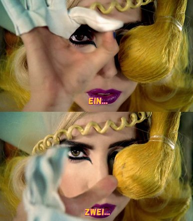 Lady Gaga turns the aok hand in front of her eye representing the 