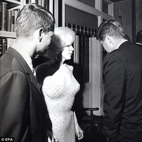 Marilyn Monroe speaks with John F. Kennedy after famously singing him "Happy Birthday Mr. President". Wearing her iconic diamond-studded dress (diamonds are associated with Presidential Models in MK symbolism), the song was actually a Beta Kitten sensually singing to the man she is servicing.