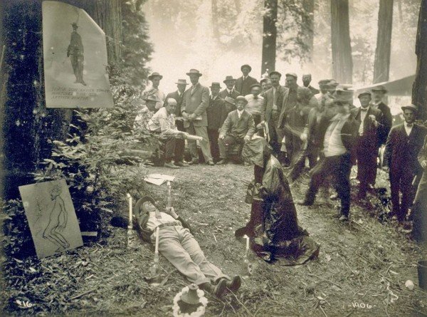 To purge himself of worldly concerns, a member of the elite Bohemian Club participated in a 1915 Cremation of Care ceremony - complete with candles and a robed and hooded comrade to guide him.