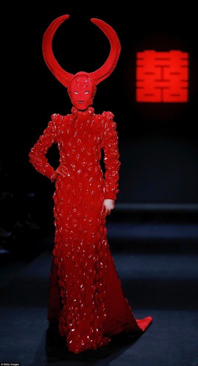 The fashion show by Chinese designer Designer Hu Sheguang was all about blood, devils, sacrifice and mind control imagery. In short, it was an unfiltered representation of the occult elite's true face. In this pic, a masked model walking around with gigantic devil horns on her head.