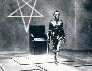 In Metropolis, Maria is a leader trusted by her people. The occult elite uses android to take on her likeness to mislead the people into following the elite's plans. Here, the android (before taking on Maria's likeness) stands before an inverted pentagram, hinting that the people that control her are all about occult and Black magic.