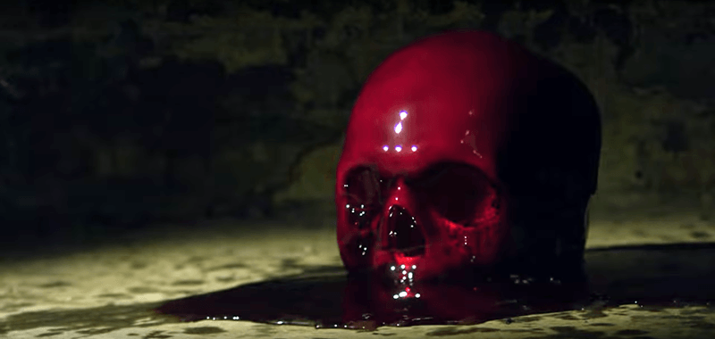Blood dropped on a skull: A symbolic way of representing the elite's love for blood sacrifices.