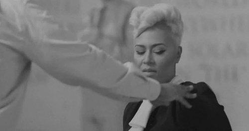 As a man steps up to Emeli, she gives a look saying "Why you touching me for?"