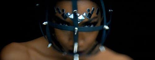 This headgear is reminiscent of BDSM stuff but is also a way to represent a slave mind being trapped and controlled by a handler.