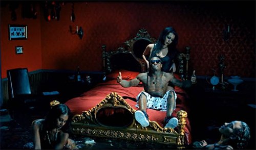 Here, Lil Wayne is in a bedroom that is full of water with women swimming in it. Aside from the fact that this water will probably cause a lot of damage to the room, it is another way to show slaves in uncomfortable settings and might be a way to subtly refer to water torture that MK slaves must go through. Also, notice the frame with butterflies in it - a way of reminding you that this is all about Monarch programming.