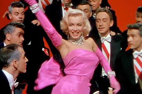 In the movie "Gentlemen Prefer Blondes", Marilyn dorns her trademark platinum blonde "Hollywood" hairdo. In this movie, she plays the role of a sexy yet materialistic woman keen to use her charm to obtain what she wants. This type of character will be repeated time and time again in popular culture.