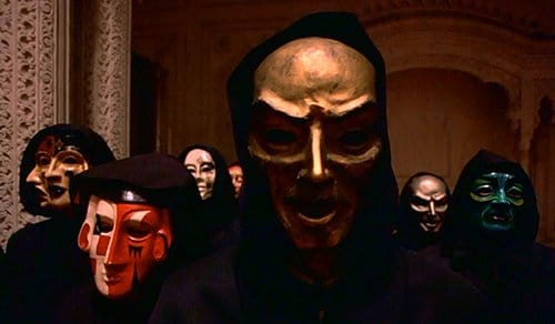 Silently looking right at the camera (and at the movie viewers), the creepy masks are silent yet disturbing reminders showing the true faces of the elite. Note that the multi-faced mask on the left is similar to the one worn at the Rothschild party above.