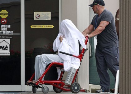 Bynes wheeled between buildings at the Hillmont Psychiatric Center on July 25. Something is definitely not right here. Is she being re-programmed?