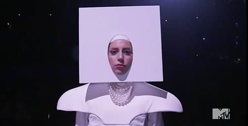 Gaga began her performance with her head stuck in a white square - maybe a way of saying that she's a "blank canvas" that is ready to be painted in any way possible to get applause.