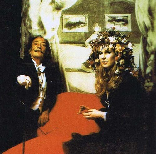 Salvador Dali with a very weird image of Marilyn Monroe behind him. She died 10 years before that event. Strange way to portray her. 