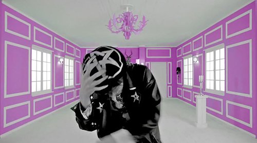 This singer has dissociated to another room. There are pentagrams all over his clothes. Combined with the Baphomet head behind, this scene refers to the black magic rituals that happen during the slaves' programming.