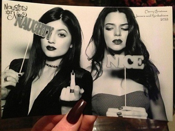 Here are Khloe's sisters (notice how people in the above pics are all related?) 2013 Christmas card. The word "Naughty" is used to hide one of her eyes. Yes, being an Illuminati pawn forces you into become "naughty". But that word is probably not strong enough.