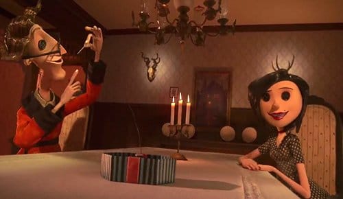 Coraline's other parents proposing her to sow buttons on her face. This creepy request represents a slave permanently escaping reality through dissociation, effectively causing them to lose their very soul. Notice the two horned (Baphomet-like) heads in the background. They are prominently lighted to emphasize the black magic/occult transformation of the MK process.