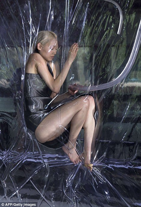 One of Lady Gaga's favorite fashion designers, Iris van Herpen, launched her Fall 2014 fashion show in Paris. Called "Biopiracy", the show featured vacuumed packed models hanging next to the runway. While this display is said to "raise questions" about the patenting of genetics, what it mostly accomplishes is dehumanizing the models and comparing them to pieces of meat.
