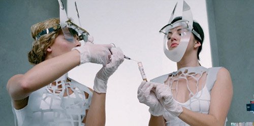 The blood is collected by nurses wearing stylized horns. 