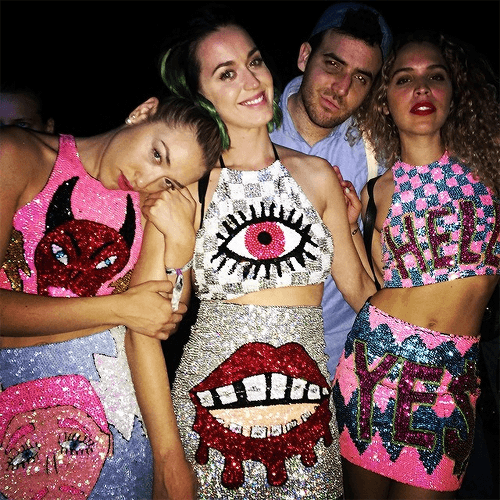 Here's Katy Perry with her girls chilling at Coachella. Their tops: A devil head, an all-seeing eye and "hell". It's like an Illuminati for kids fashion show.