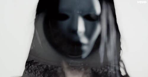 Woman with a creepy "Eyes Wide Shut"-type mask.