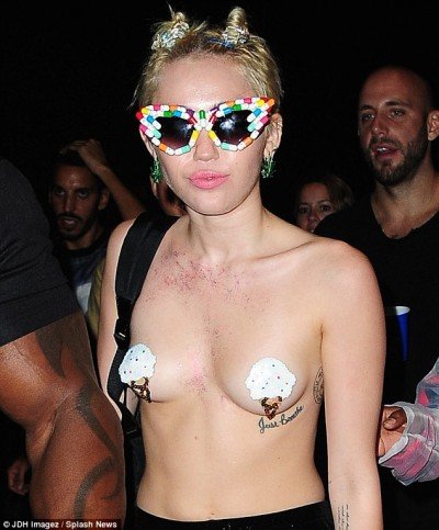 Here's a direct result of a system that is preying on children. Miley Cyrus walking around with ice cream cones on her chest while wearing sunglasses made of pills, basically telling us : Her vision is "shaded" by MK ULTRA medication.