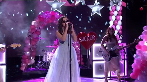 Charli began the performance dressed in a virginal gown in a setting akin of a school prom.