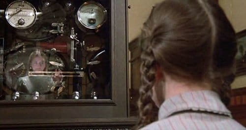 While looking at the machine, Dorothy sees another girl as her reflection. The electroshock machine is the gateway to her alter persona - Ozma - the queen of Oz.