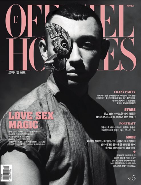 Formichetti on the cover of L'Officiel with a butterfly hiding one eye, confirming that he is all about the MK industry.
