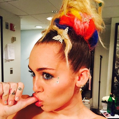 Another month, another MK-inspired Miley Cyrus Instagram pic. In this pic: Butterflies in her hair (Monarch programming), sucking her thumb as if she was broken down to the state of an infant and showcasing her triangle and all-seeing eye tatoos. 