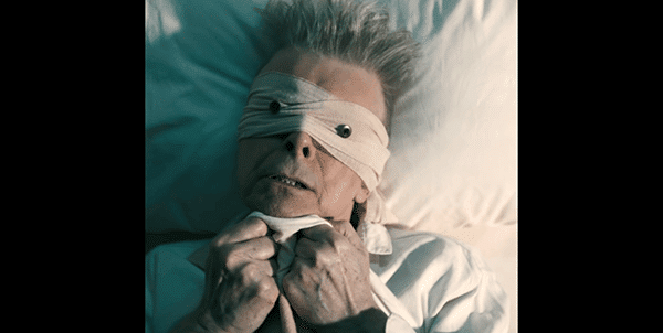 In the role of the "blind follower", we see Bowie as the simple man, the regular human who is physical weak, laying on his deathbed and scared of things to come.