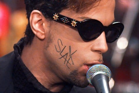 Prince, with the word "Slave" written across his face is shown performing in New York's Rockefeller Plaza on July 9, 1996.