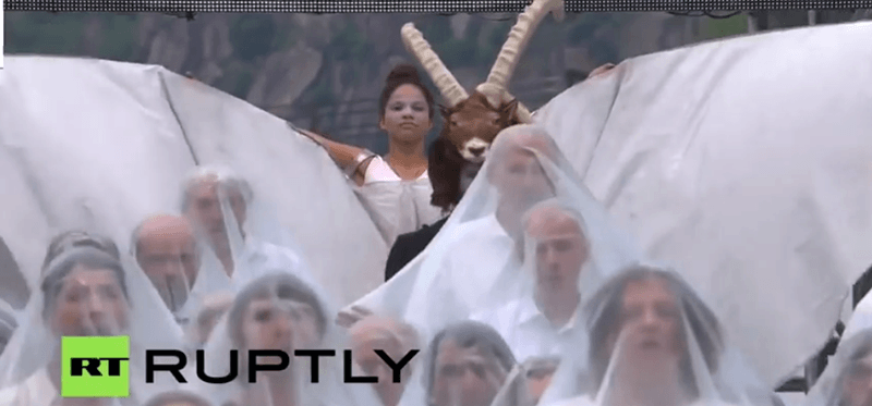 The goatman makes his entrance, preceded by people wearing white veils ... like brides before a wedding.