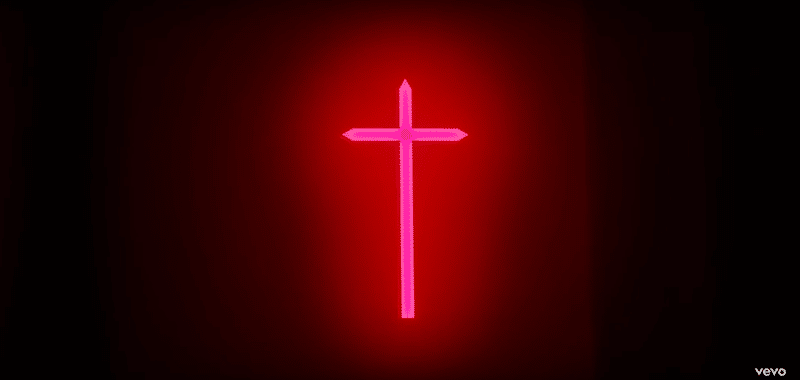 A big illuminated cross hangs in his room.